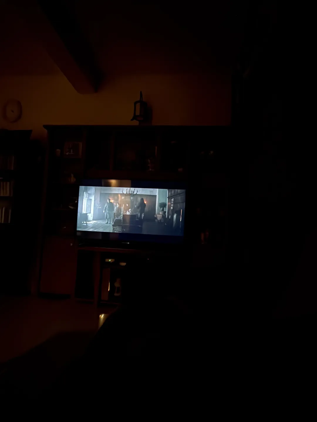 A dark room lit by a projector screen