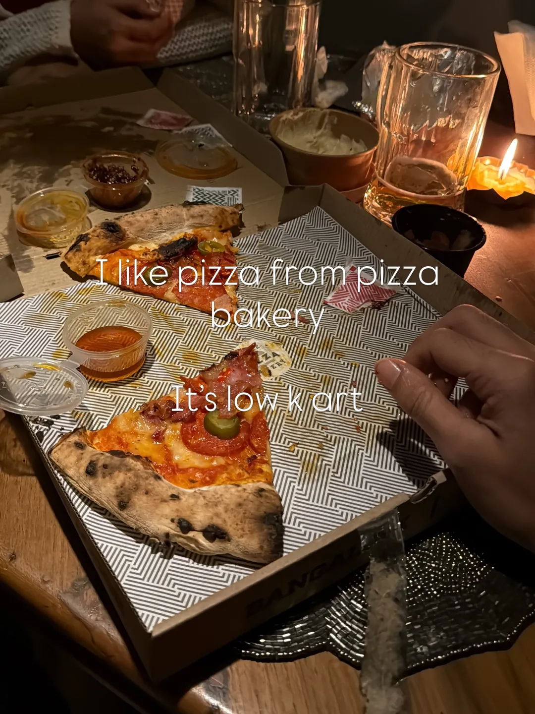 Pizza by candlelight, captioned: I like pizza from Pizza Bakery, it's low key art