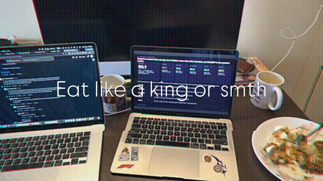 Two laptops and a plate of food, captioned: eat like a king or smth