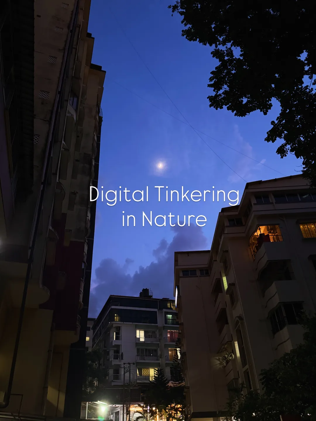 Evening sky between apartment blocks, captioned: digital tinkering in nature